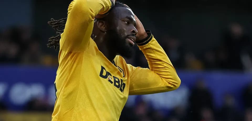 Player in yellow jersey holding head in frustration