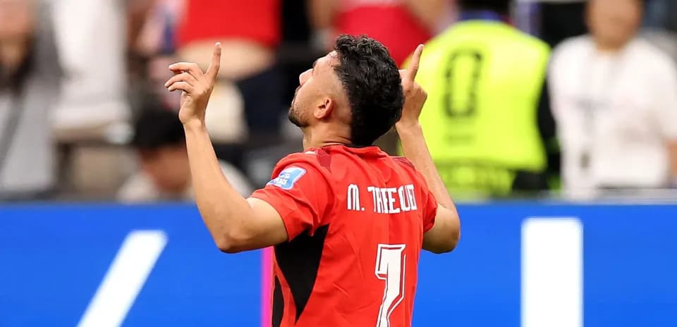 Player celebrating a goal with raised hands