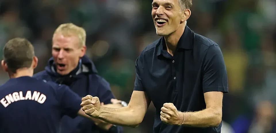 Coach celebrating victory with staff on sidelines