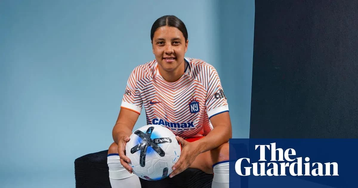 Player posing with soccer ball in studio