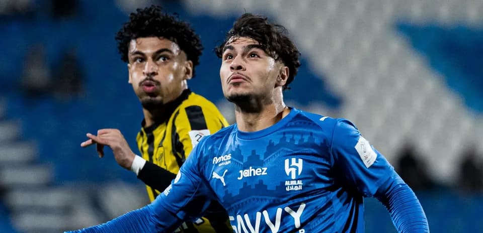 Two football players competing for the ball