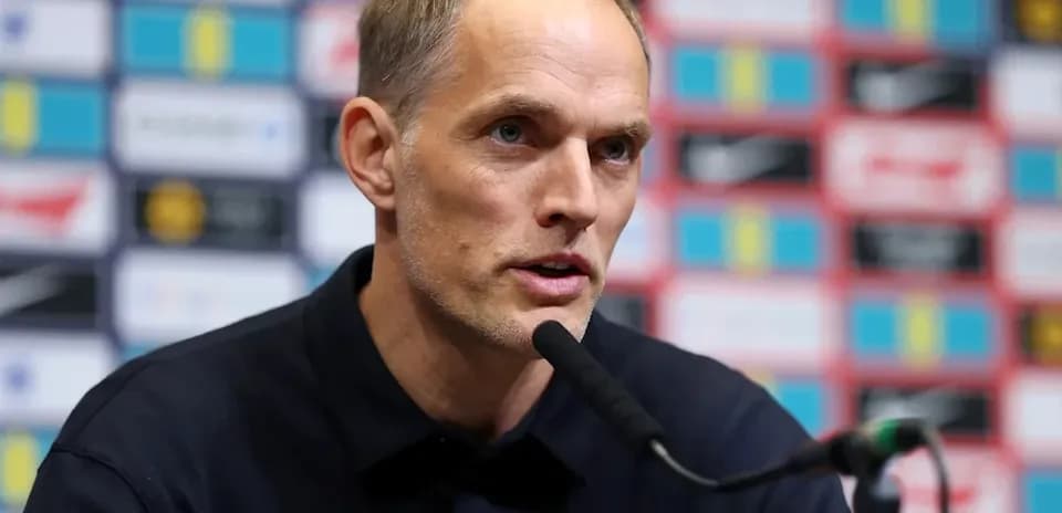 Manager speaking at press conference with microphone