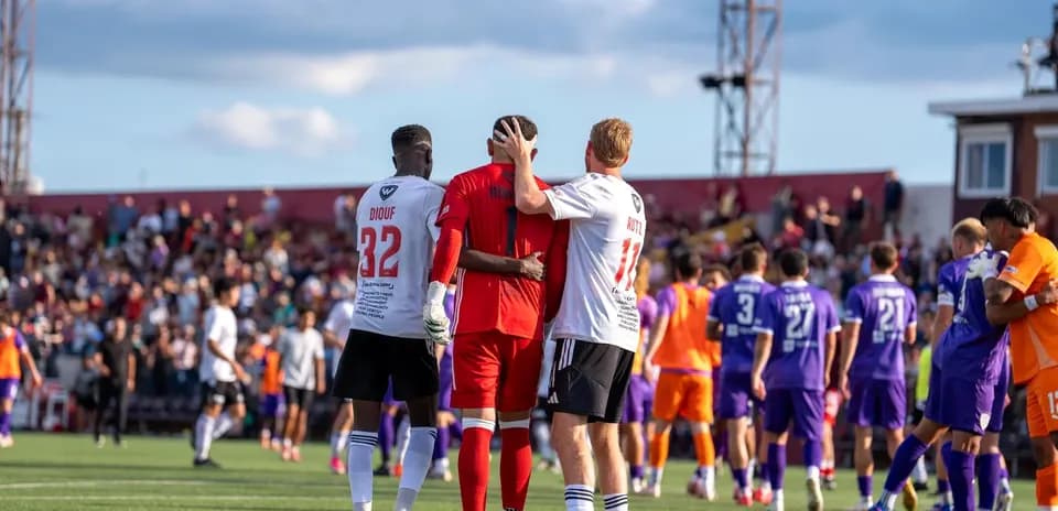 Players celebrating after match in USL League One