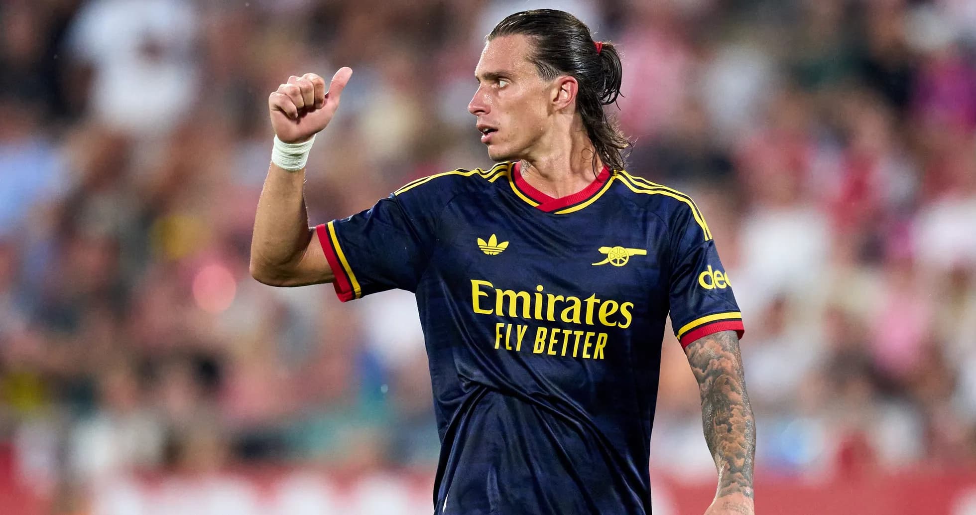 Player gesturing during match in Arsenal kit