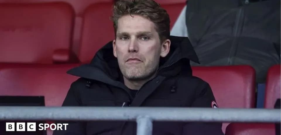 Man sitting in stadium seat during match