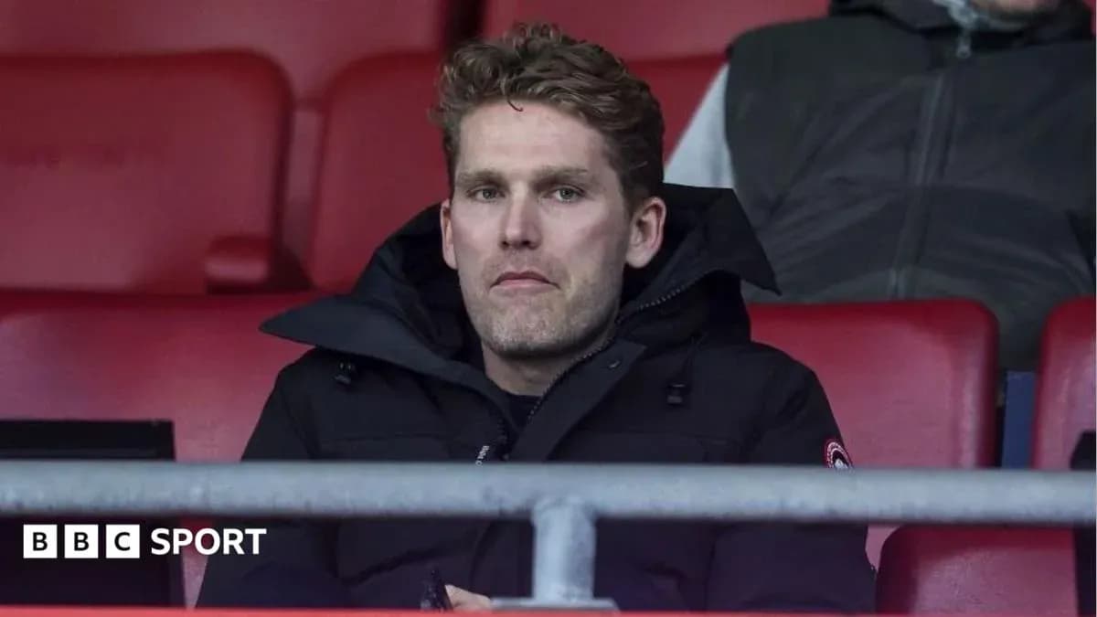 Man sitting in stadium seat during match