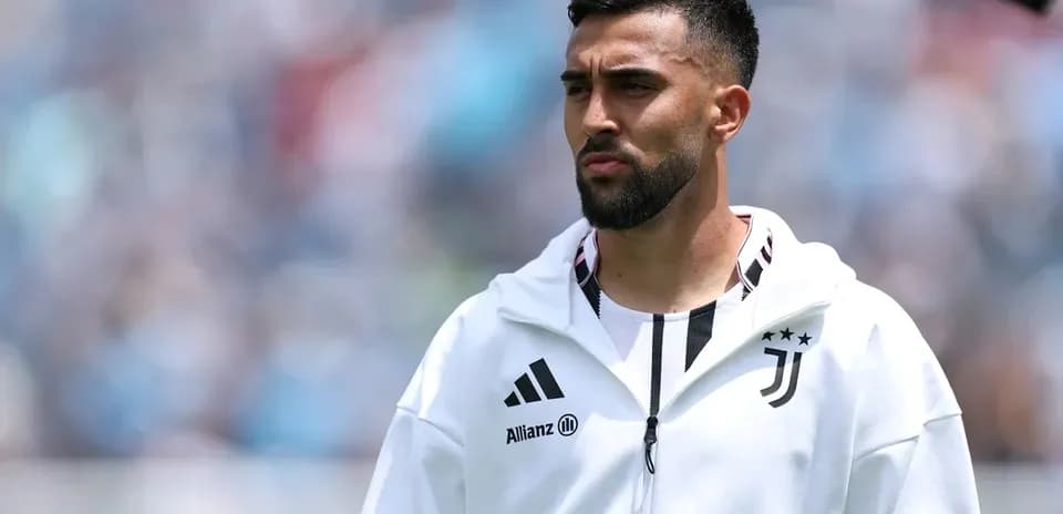 Player in Juventus jacket during match warm-up