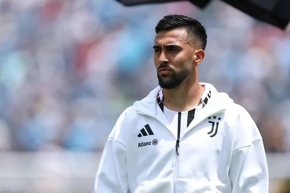Player in Juventus jacket during match warm-up