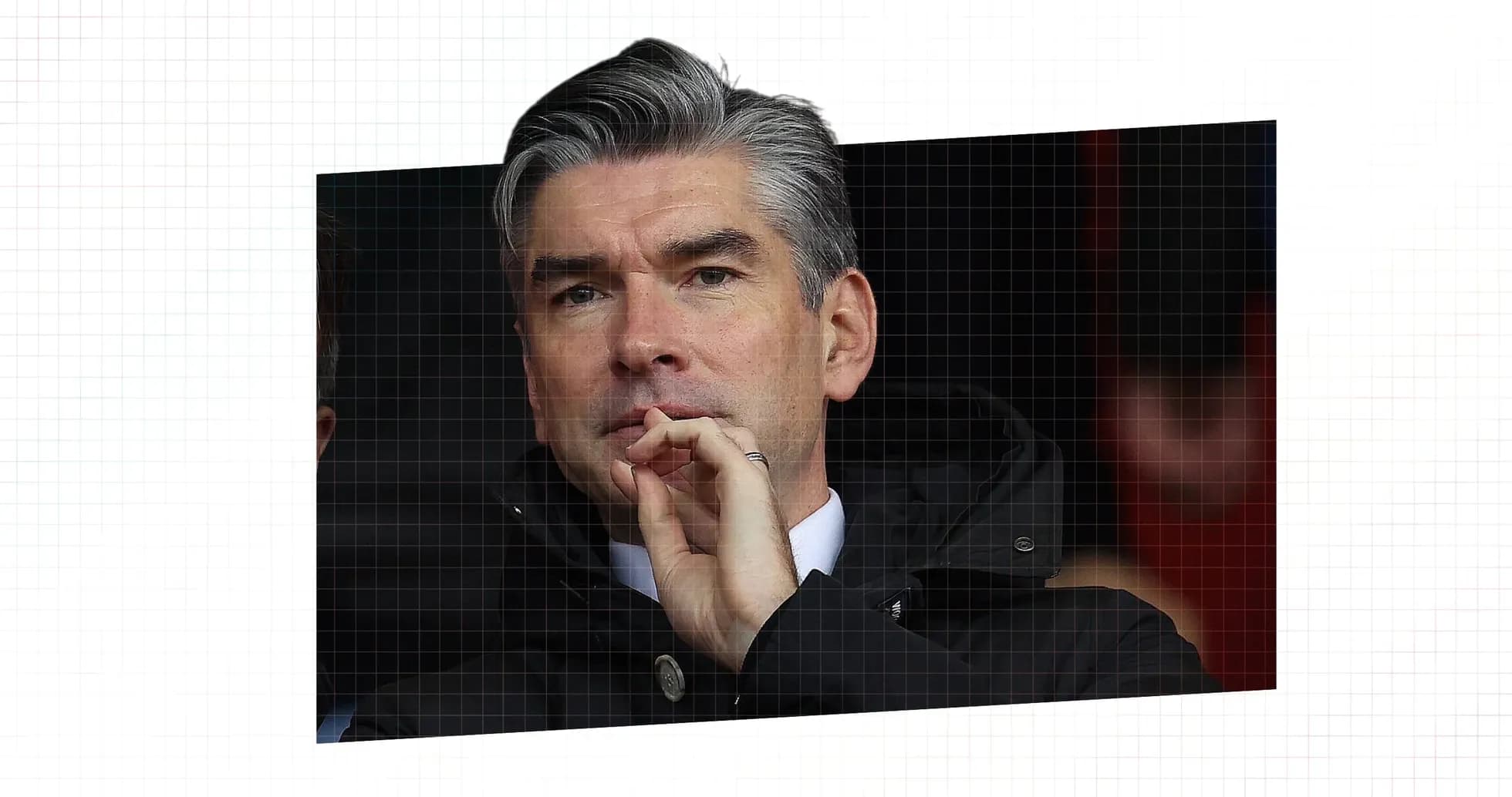 Man in a black jacket observing a match