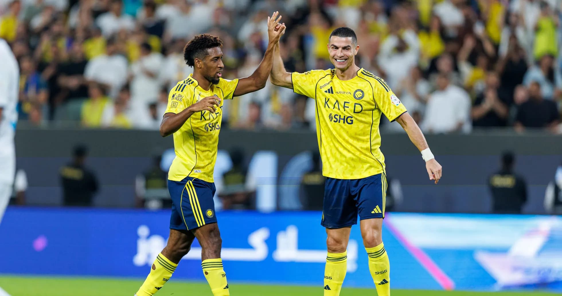 Two players celebrating a goal during match