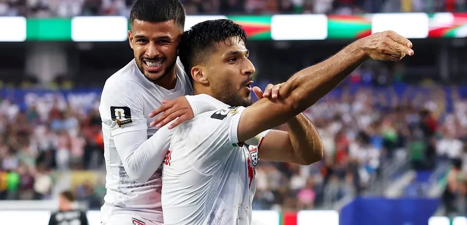 Two players celebrating a goal during a match