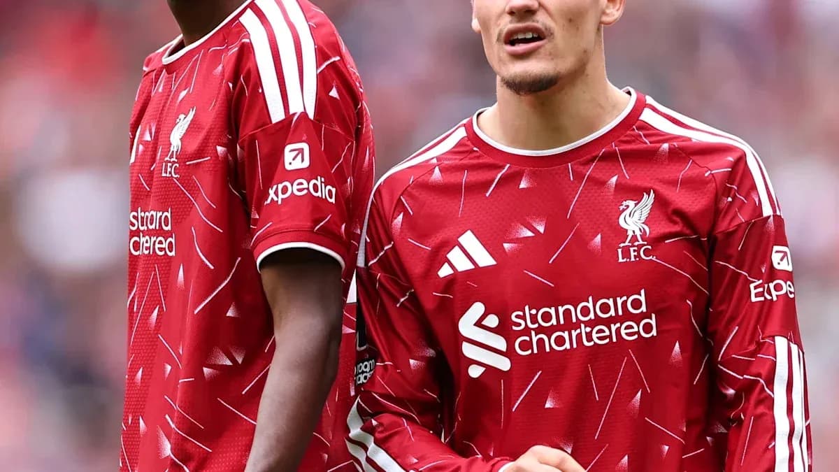 Two Liverpool players in red jerseys during match