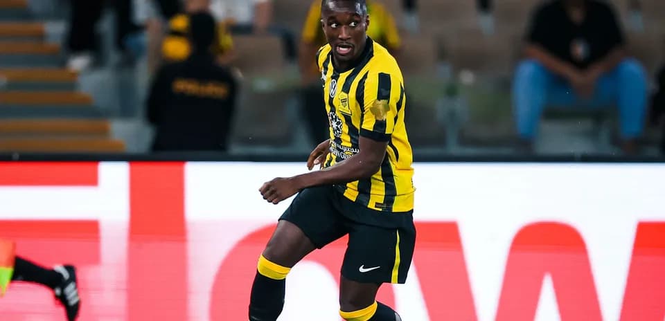 Player in yellow and black uniform during match