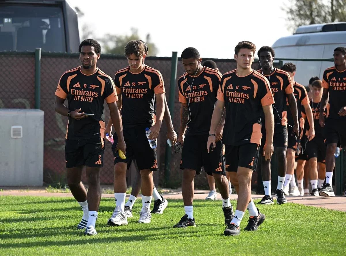 Arsenal players walking on training ground in kits