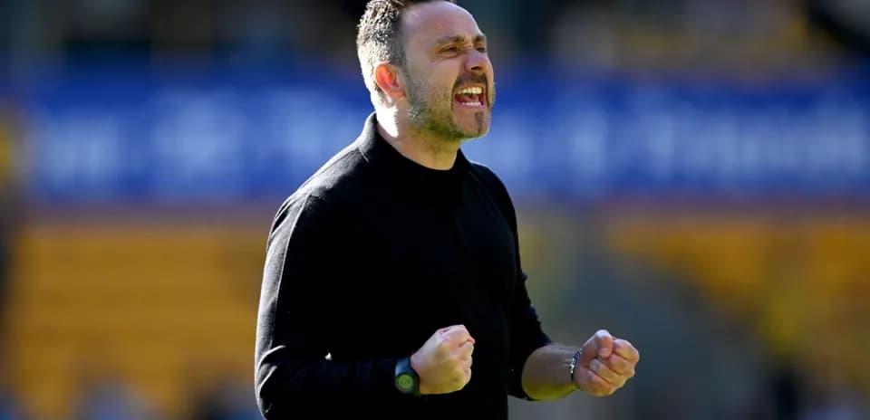 Coach celebrating with clenched fists during match