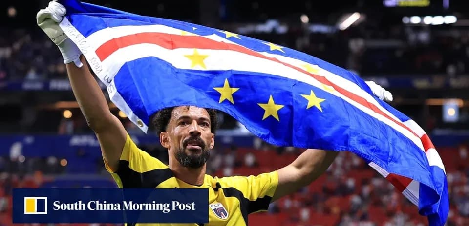 Player celebrating with Cape Verde flag in stadium