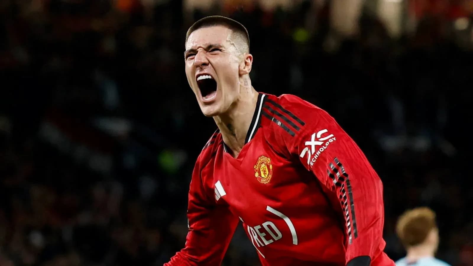 Player celebrating a goal in Manchester United jersey