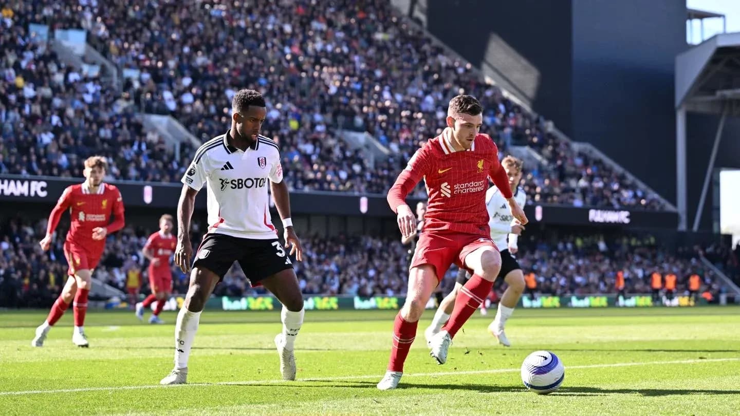 Liverpool player dribbling against Fulham defender