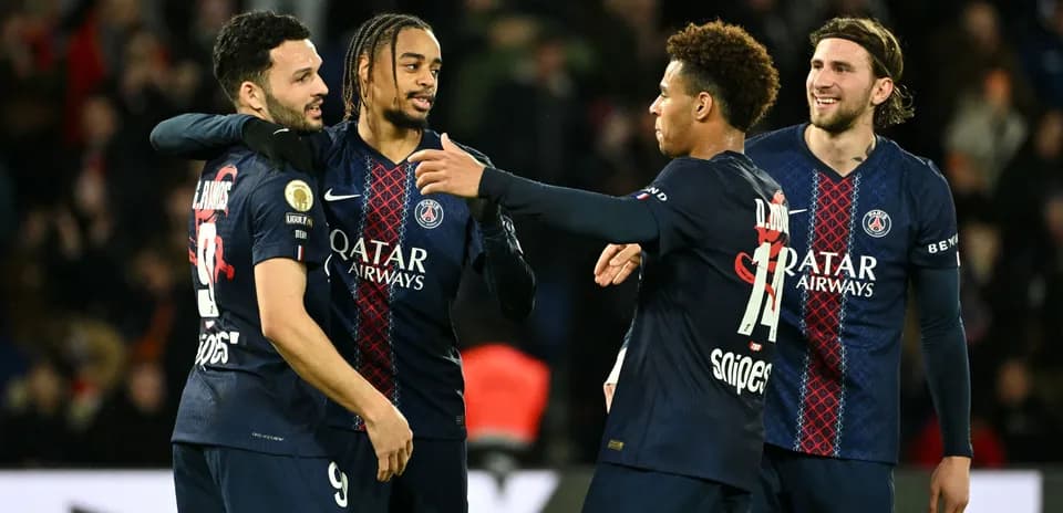 Paris Saint-Germain players celebrating together on field