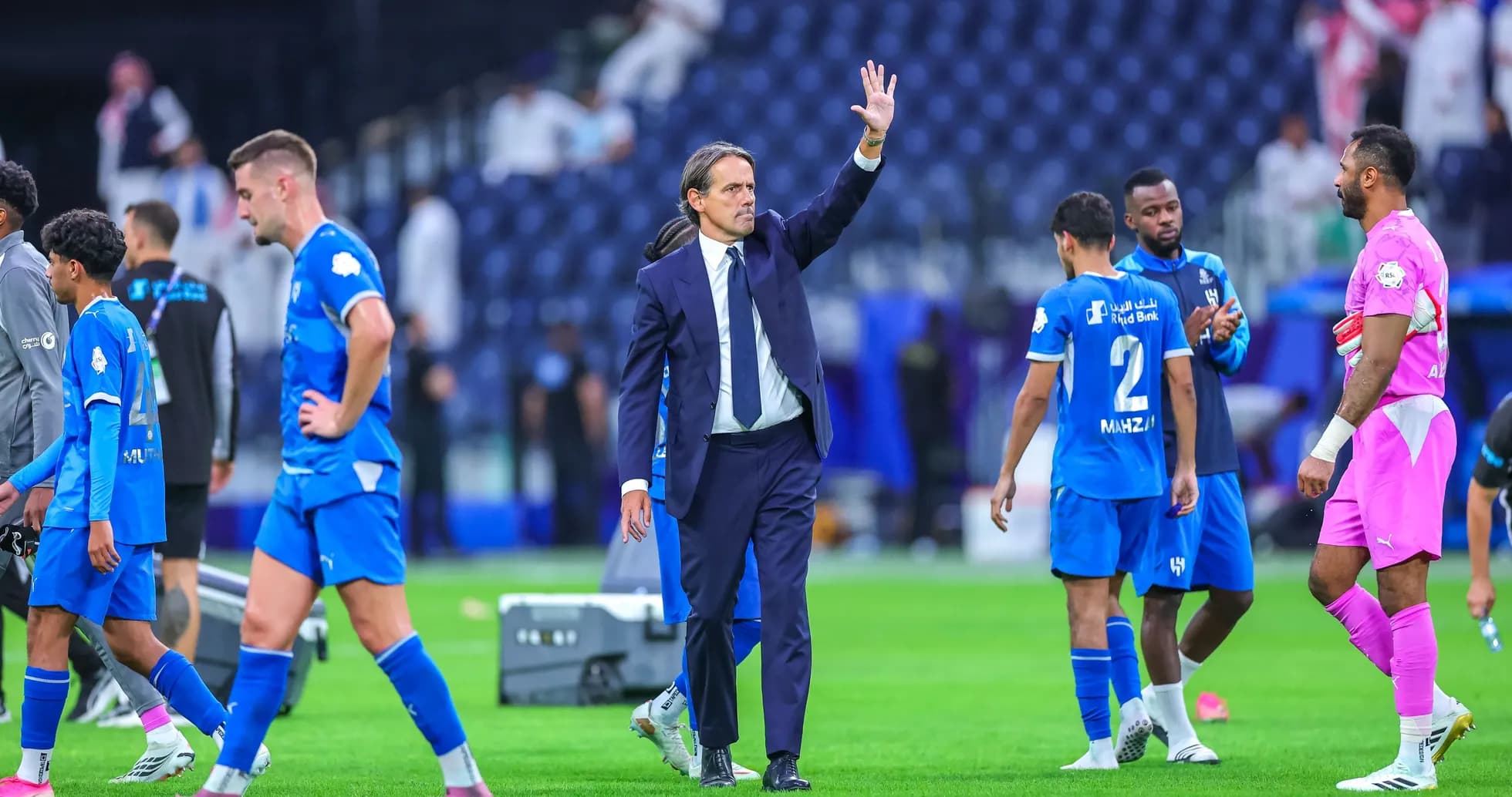 Coach waving to players after the match