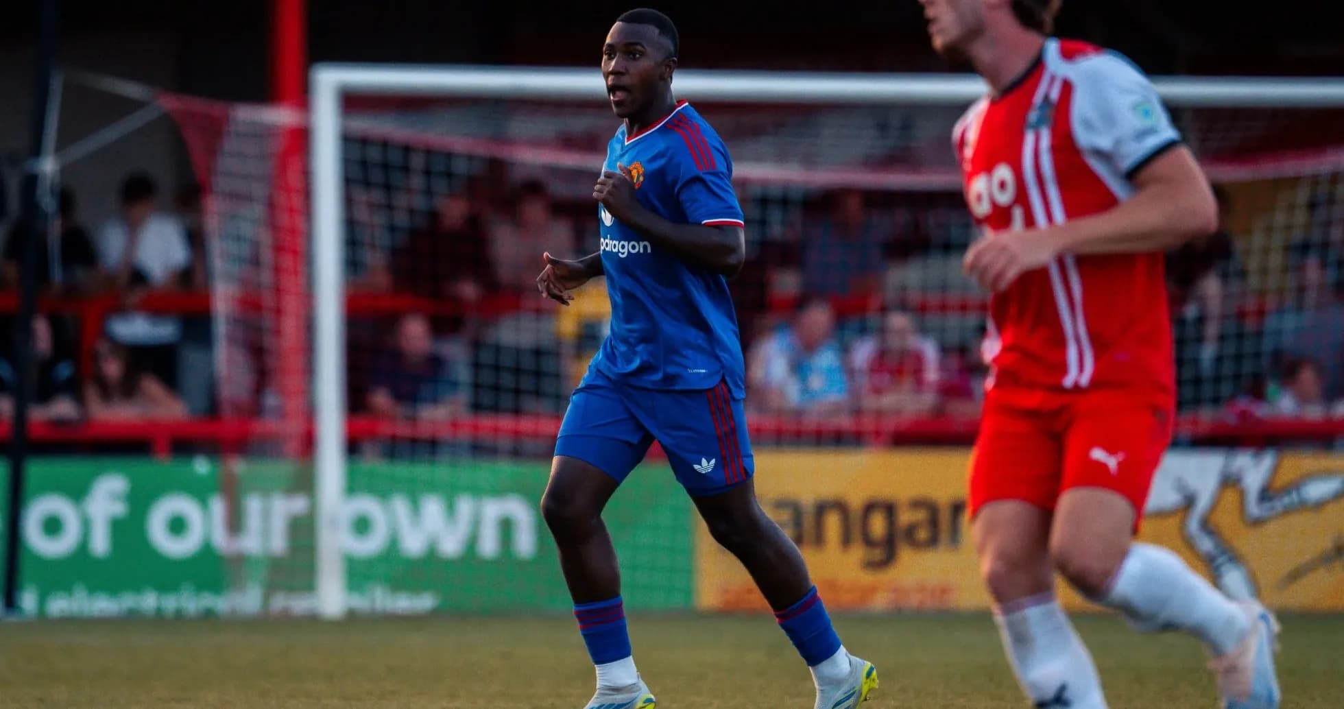 Player in blue kit running on the pitch