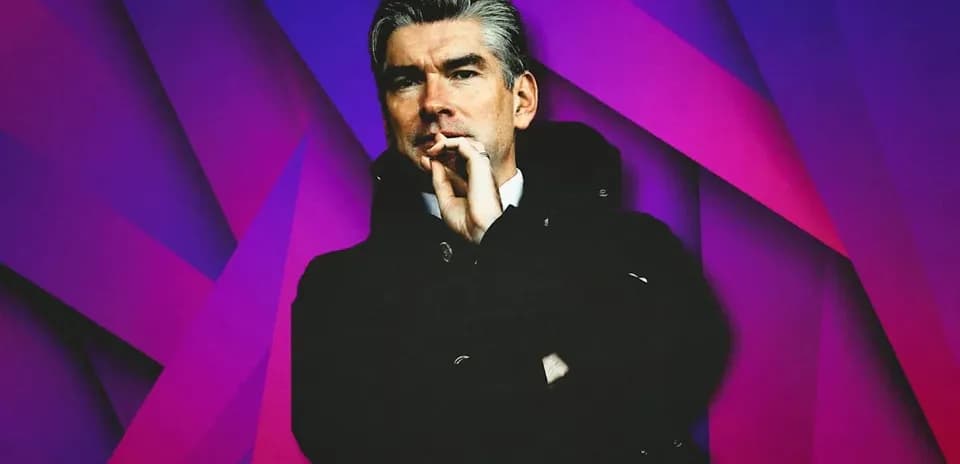 Man in black coat with a colorful background