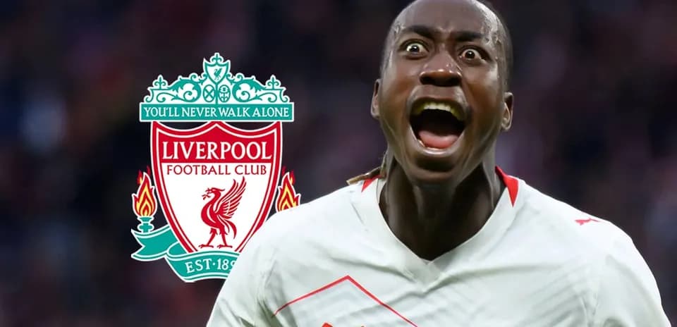 Player celebrating in front of Liverpool FC logo