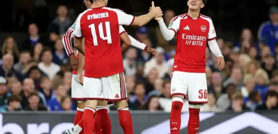 Two Arsenal players celebrating during a match