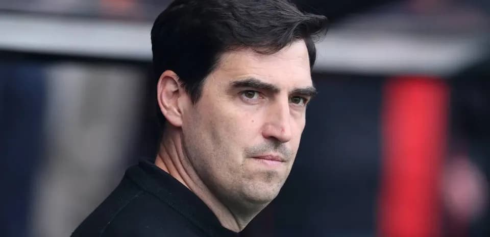 Coach observing from the sidelines during match