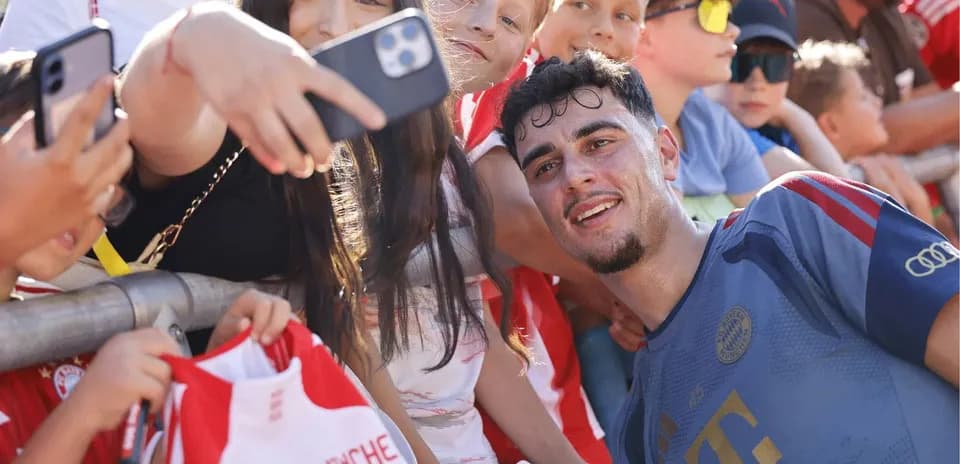 Player taking selfie with fans at event