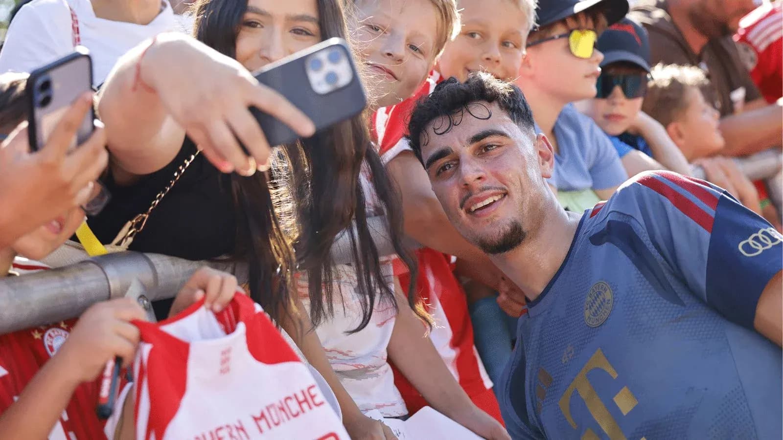 Player taking selfie with fans at event