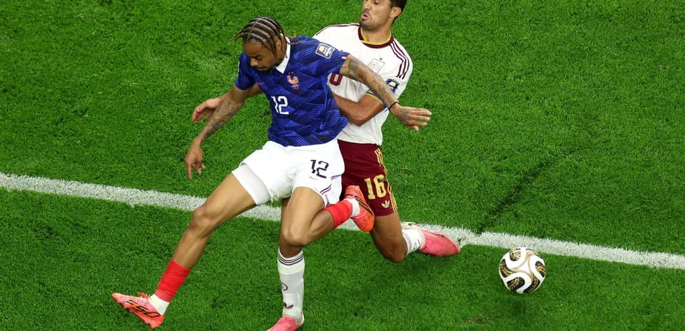 Two players challenging for the ball during match