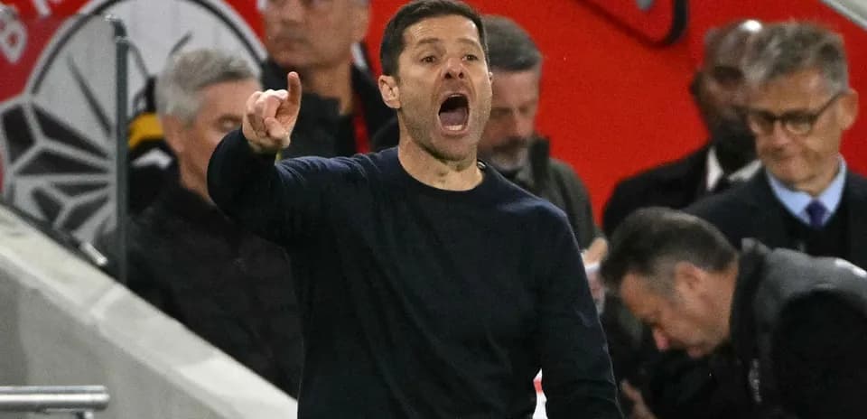 Coach gesturing passionately from the sidelines during match