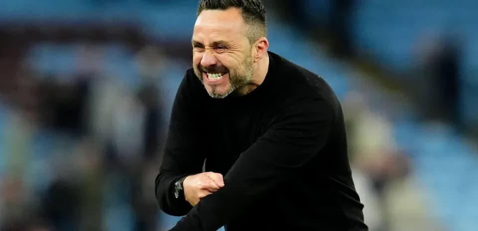 Coach celebrating a goal on the sidelines