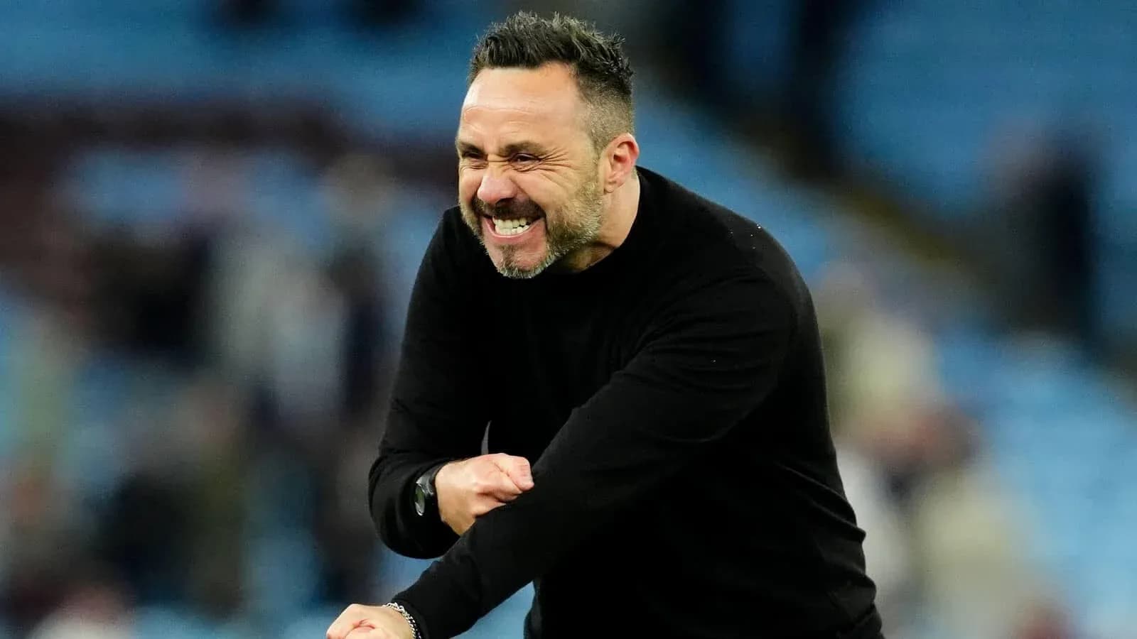 Coach celebrating a goal on the sidelines