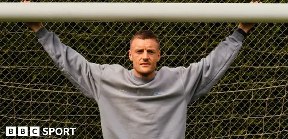 Player posing with arms on goalpost