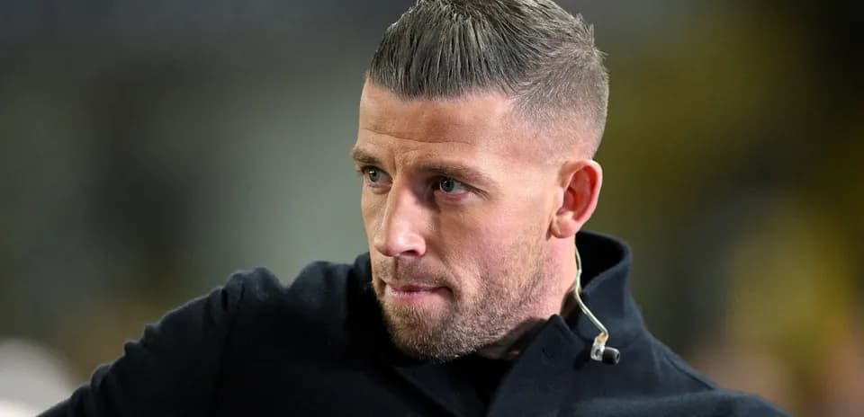 Man with short hair in a black coat