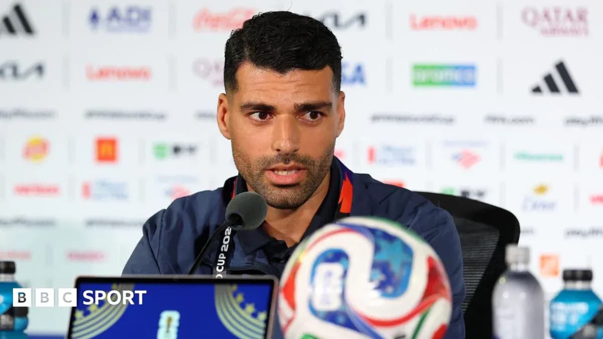 Player speaking at press conference with soccer ball