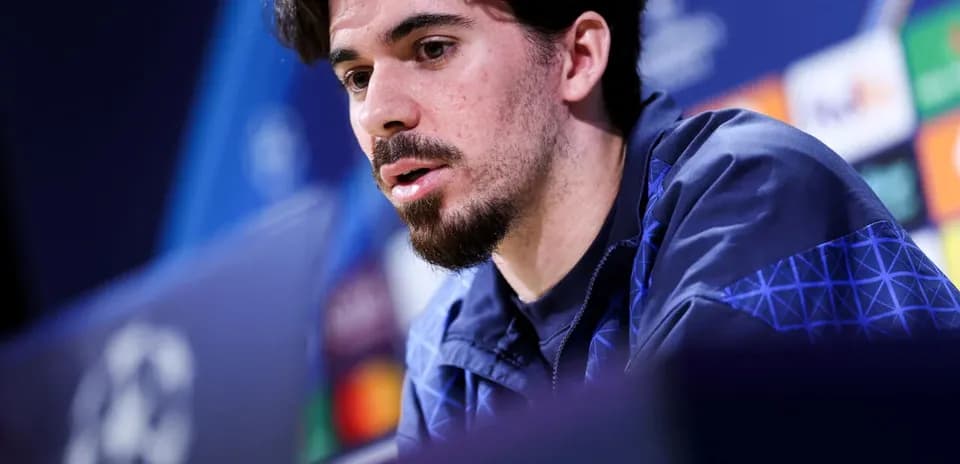 Player speaking at pre-match press conference podium