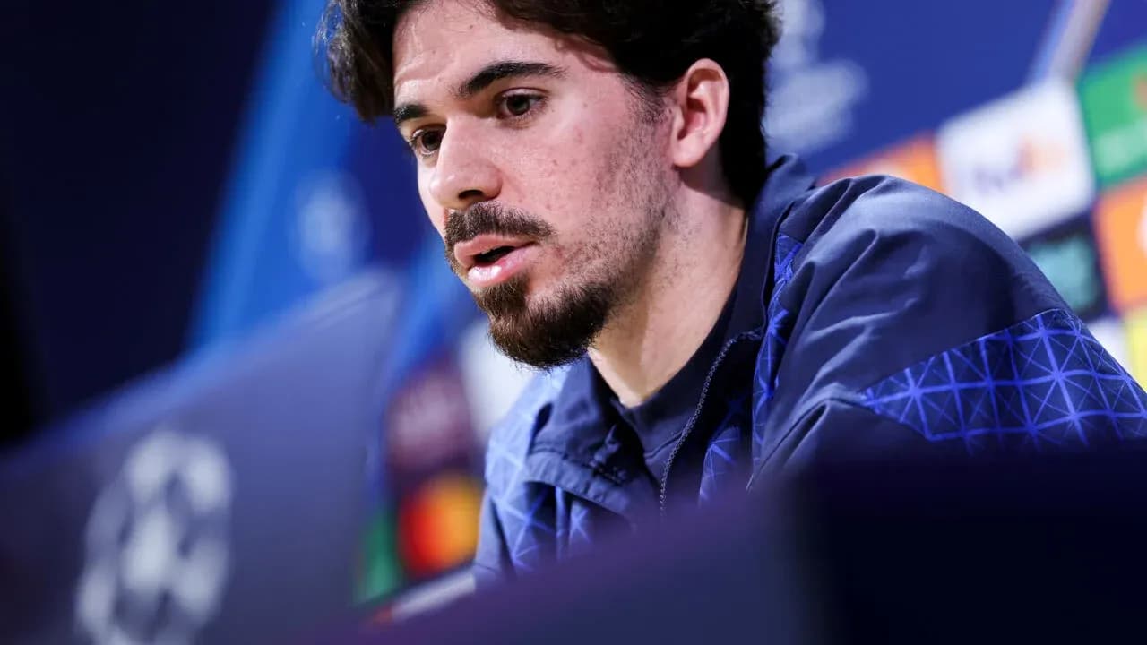 Player speaking at pre-match press conference podium