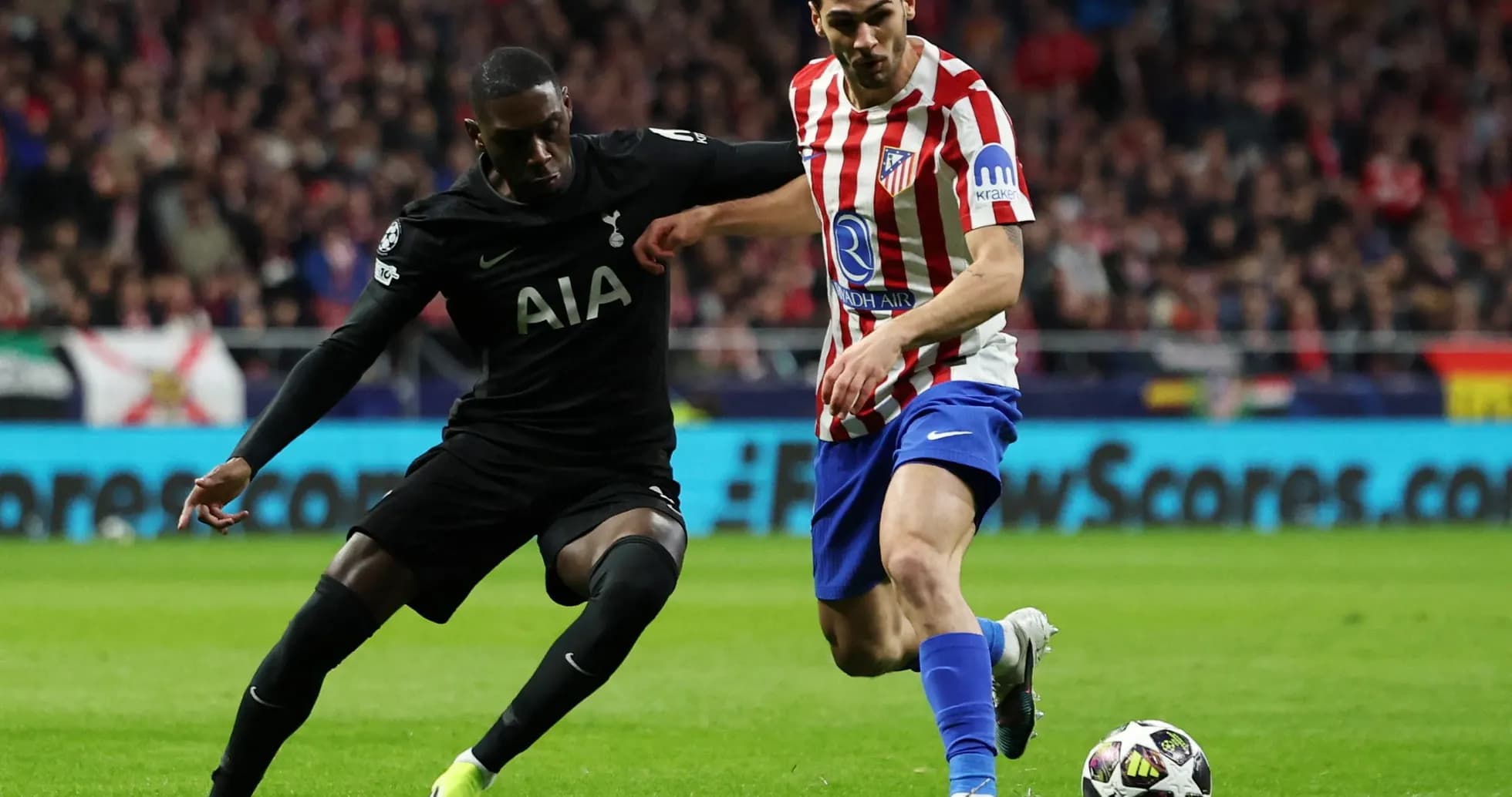 Player from Tottenham challenges Atletico Madrid player