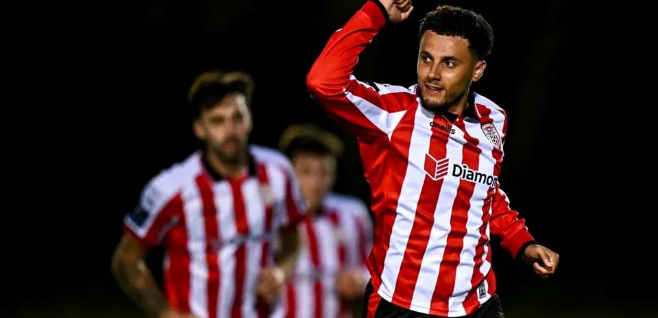 Player celebrating a goal with teammates in background