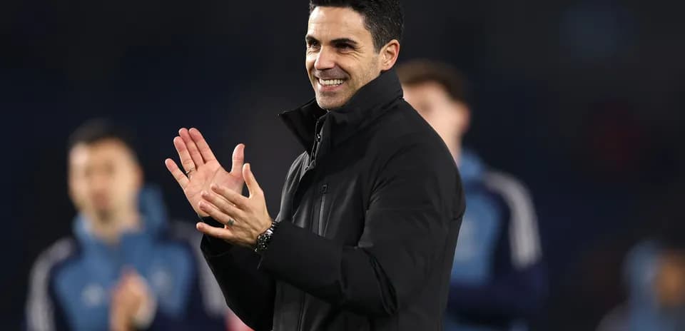 Manager clapping and smiling during a match
