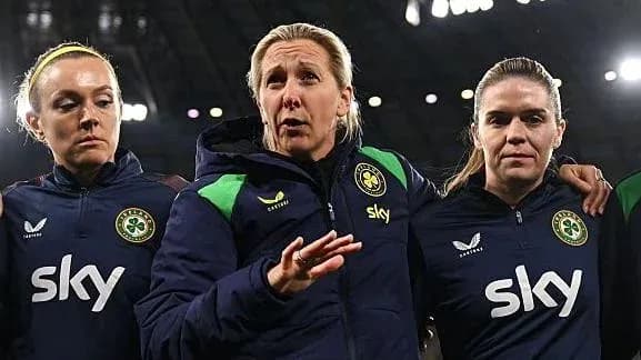 Coach discussing strategy with two players