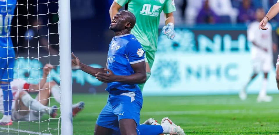 Player kneeling near goal post after a missed chance