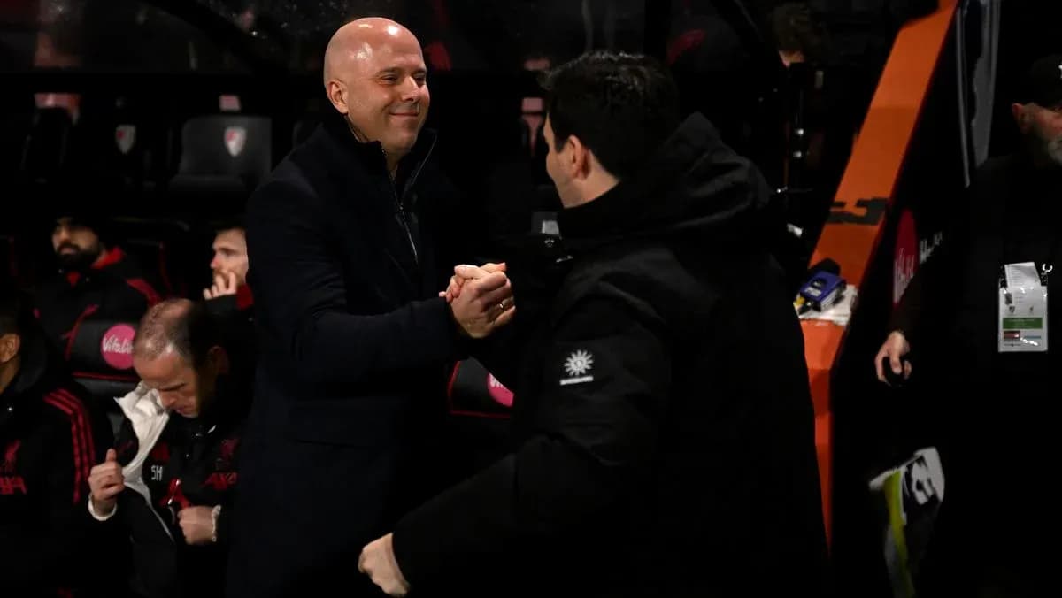 Two coaches shaking hands on the sidelines