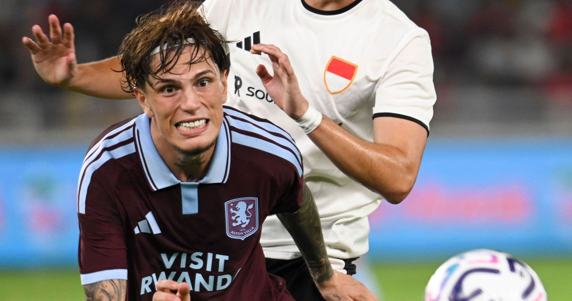 Aston Villa player being challenged during match