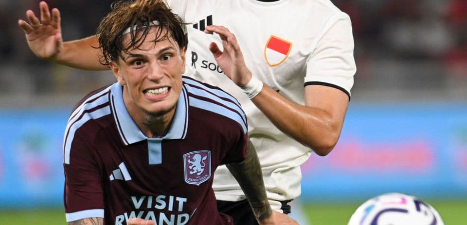 Aston Villa player being challenged during match