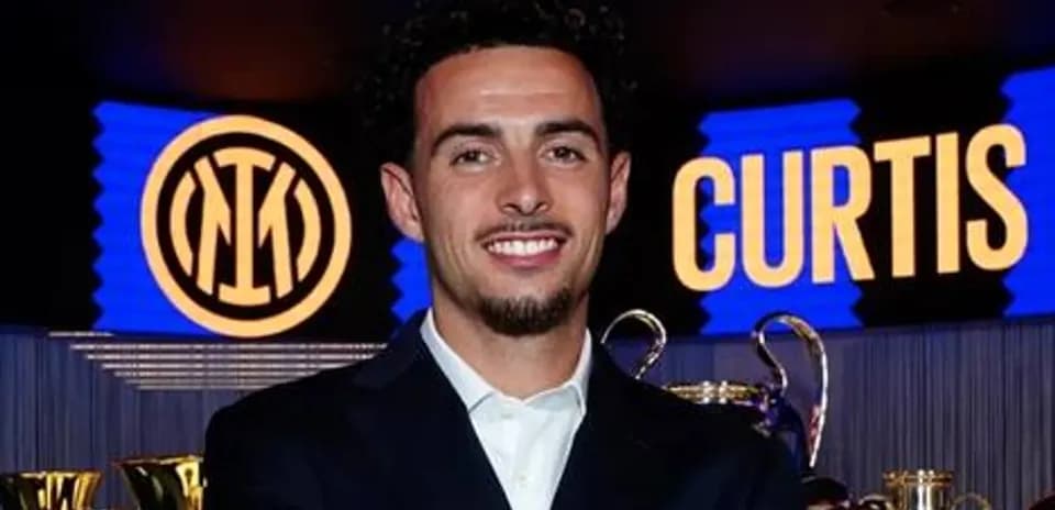 Player posing with trophies and Inter Milan logo