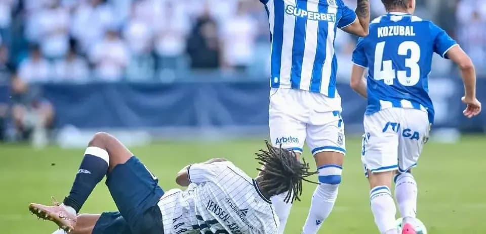 Lech Poznan player evading Aarhus defender